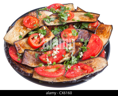 fried eggplants, red tomato and garlic on black plate isolated with white background Stock Photo