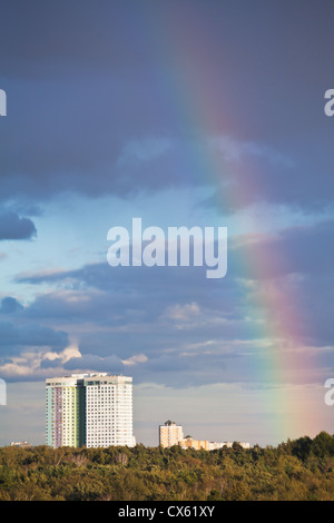 autumn rainbow under city park in dark blue sky Stock Photo