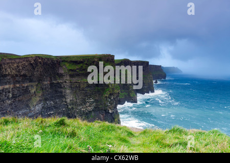 The Cliffs of Moher are located at the southwestern edge of the Burren region in County Clare, Ireland. They rise 120 metres abo Stock Photo