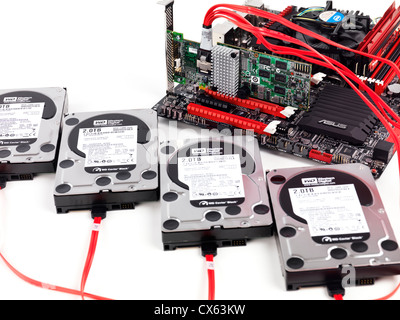 Closeup of four hard drives connected to computer motherboard with a RAID controller Stock Photo