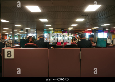 Passengers queuing the immigration counters in Changi International Airport. Stock Photo