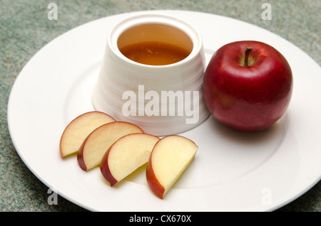 Traditional Jewish food, apple and honey for the holiday of Rosh Hashana (Jewish New Year).