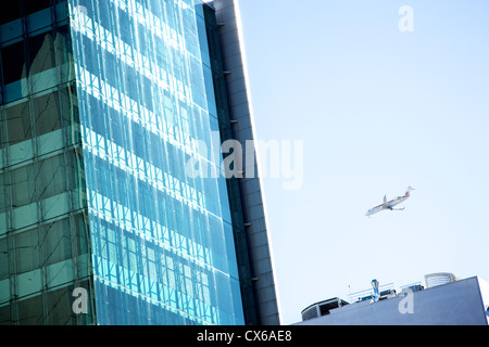Aircraft flying over Lisbon business district Stock Photo