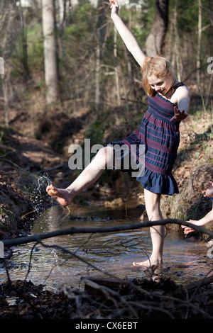 Girl kicking her feet through the water in Mooresville, North Carolina, USA Stock Photo