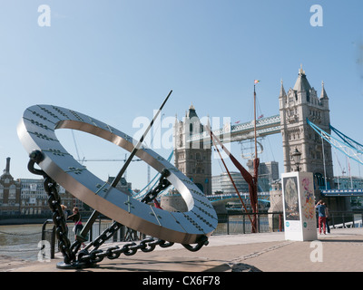 Tower Bridge from St Katherine Docks area with the giant sundial in the foreground Stock Photo