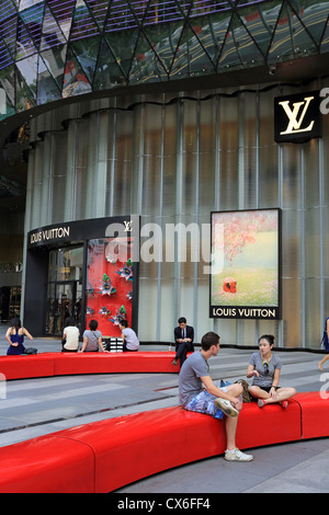 People sitting in a public area at ION Orchard on Orchard Road, Singapore Stock Photo