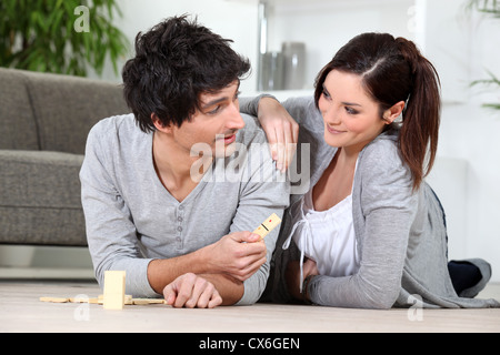 Couple playing dominoes Stock Photo