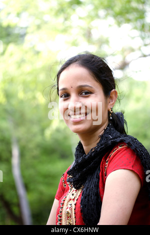 Smiling young Indian woman at outdoors Stock Photo