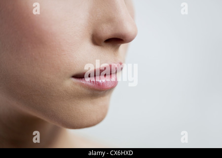 Close up of a young womans mouth, closed Stock Photo