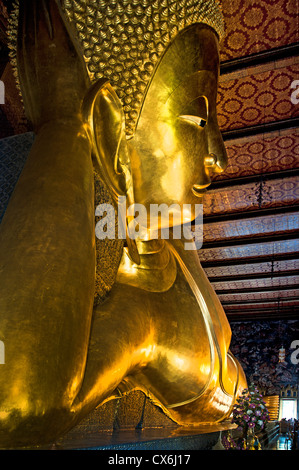 Big Reclining golden Buddha statue (Phra Buddhasaiyas) at Wat Pho Bangkok 46 m long Thailand Stock Photo
