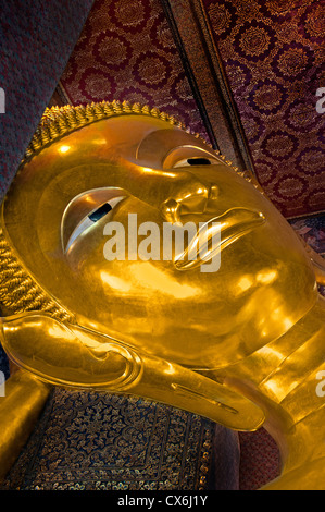 Big Reclining golden Buddha statue (Phra Buddhasaiyas) at Wat Pho Bangkok 46 m long Thailand Stock Photo