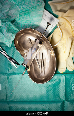 Various surgical instruments on a surgical drape Stock Photo