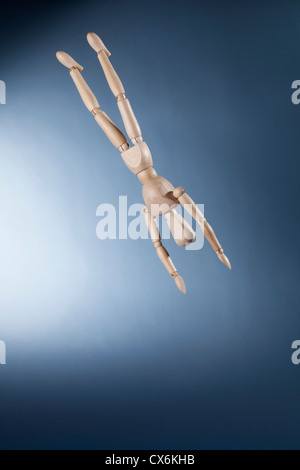 An upside down artist's figure falling in mid-air Stock Photo