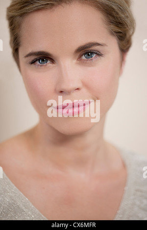 A young woman with her hair up, looking to camera Stock Photo