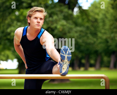 Handsome athlete with a serious expression on his face doing his exercise routine Stock Photo