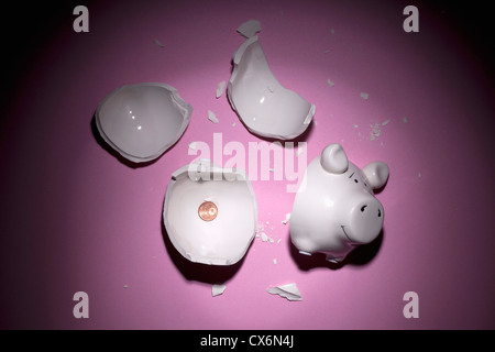 A broken piggy bank with only one Euro cent Stock Photo