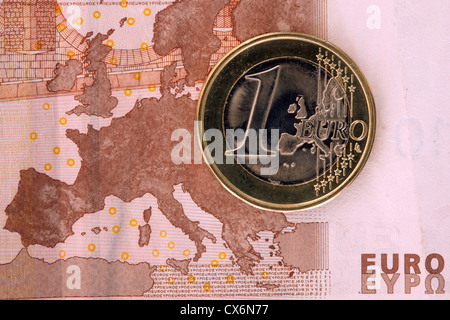 Detail of a ten Euro banknote with a one Euro coin on top of it Stock Photo