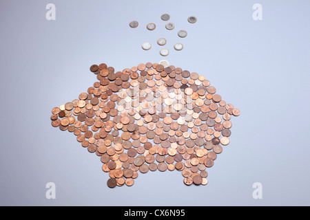 Euro coins falling into a piggy bank made from arranged European coins Stock Photo