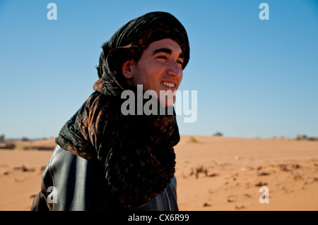 A young Berber man smiling in the Saharan Desert Stock Photo