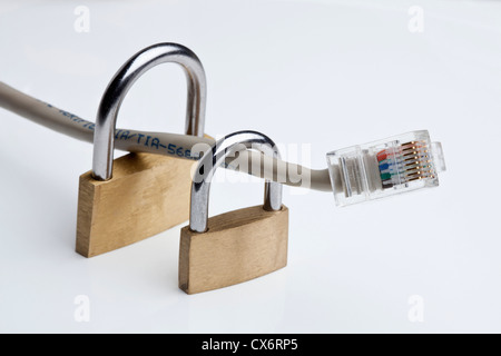 Two padlocks around an Ethernet cable Stock Photo