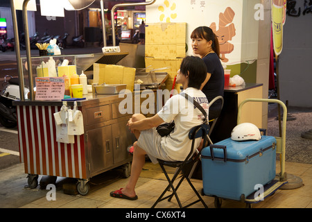 Vendors at a street food stall in Fengjia night market, Taichung, Taiwan Stock Photo