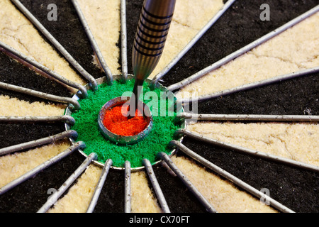 a dart hits target in the centre of a darts board good business concept for success Stock Photo