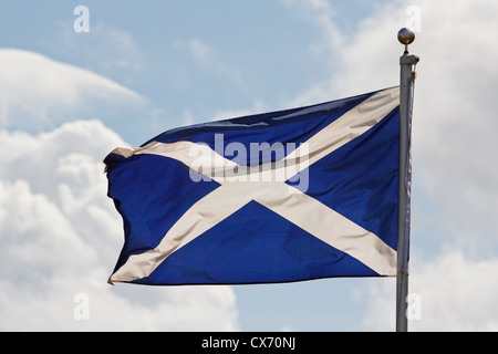 the blue and white cross of st andrew the national flag of scotland ripples in the wind on flagpole Stock Photo