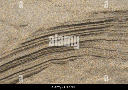 Rippled sand / fluvial ridges on beach / shoreline after tide has just retreated. Perranporth beach, Cornwall. Mars-like flow patterns concept. Stock Photo