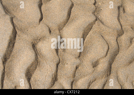 Rippled sand / fluvial ridges on beach / shoreline after tide has just retreated. Perranporth beach, Cornwall. Mars-like flow patterns concept. Stock Photo
