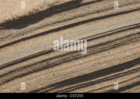 Rippled sand / fluvial ridges on beach / shoreline after tide has just retreated. Perranporth beach, Cornwall. Mars-like flow patterns concept. Stock Photo