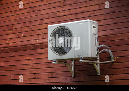 Air conditioner on the wall of boards. Stock Photo