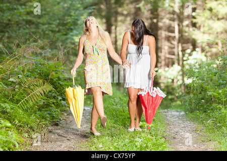 Amused women walking in the woods Stock Photo