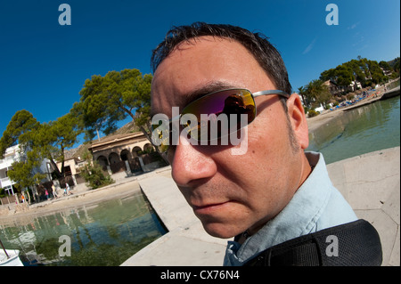 Close up view of man wearing mirrored sunglasses on a summers day. Stock Photo