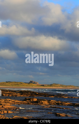 Bamburgh Castle on the Northumberland coast seen from Seahouses on a Summer morning. Stock Photo