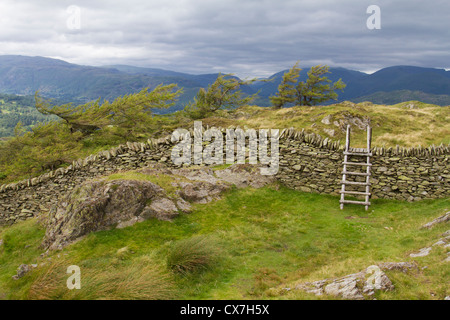 Stile over dry-stone wall on Black Crag, Lake District, England Stock Photo