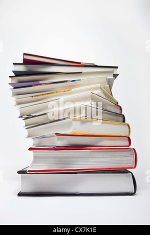 A variety of hardcover books arranged in a spiraling stack Stock Photo