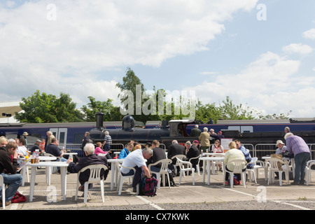 Visitors to Railfest 2012 at the National Railway Museum in York sit  for refreshments in and outdoor catering area. Stock Photo