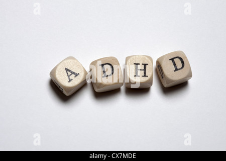 Lettered cubes arranged to spell the abbreviation ADHD Stock Photo