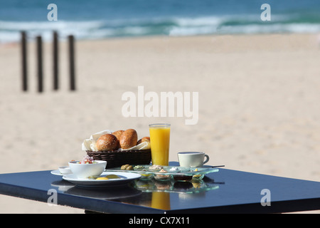 Israeli Breakfast served on the beach Stock Photo