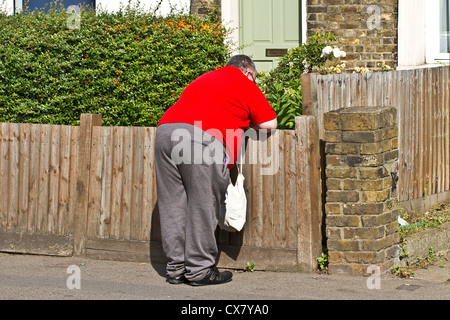 A heavyweight man pausing for breath Stock Photo