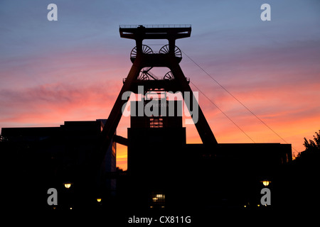 colourful sunset at the winding tower of shaft 12 at Zollverein Coal Mine Industrial Complex in Essen, Germany Stock Photo