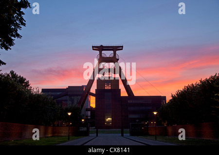 colourful sunset at the winding tower of shaft 12 at Zollverein Coal Mine Industrial Complex in Essen, Germany Stock Photo