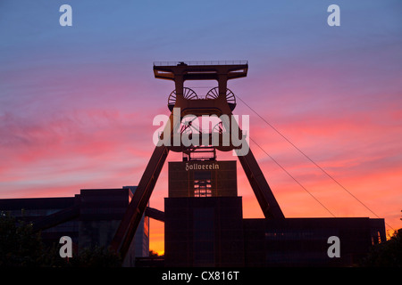 colourful sunset at the winding tower of shaft 12 at Zollverein Coal Mine Industrial Complex in Essen, Germany Stock Photo