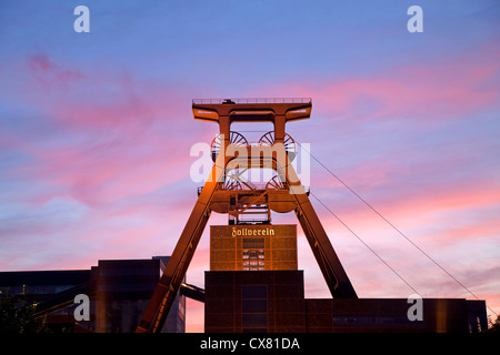 colourful sunset at the winding tower of shaft 12 at Zollverein Coal Mine Industrial Complex in Essen, Germany Stock Photo