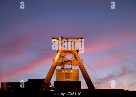 colourful sunset at the winding tower of shaft 12 at Zollverein Coal Mine Industrial Complex in Essen, Germany Stock Photo