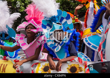 Young Bahamian girls dressed in Junkanoo costumes celebrate graduation in Nassau , Bahamas. Stock Photo