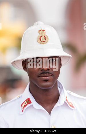 A member of the Royal Bahamas Police wearing a Wolseley pith helmet patrols Parliament Square Nassau, Bahamas. Stock Photo