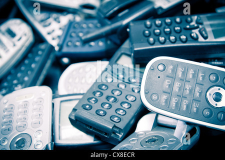 scatered old cellphones color processed blue e-waste Stock Photo