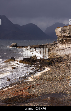 Dark clouds over the Black Cuillin mountains with Elgol beach in the foreground, Elgol, Isle of Skye, Scotland, UK Stock Photo