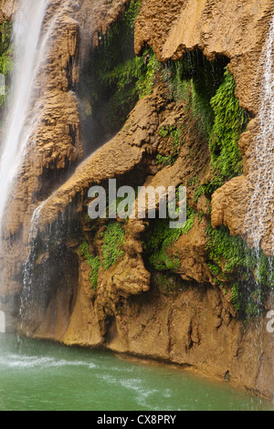 ANISAKAN FALLS drops into a green pool a few miles outside of PYIN U LWIN also known as MAYMYO - MYANMAR Stock Photo